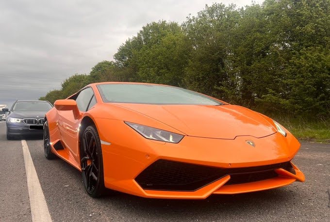 Orange Lamborghini, with no front number plate